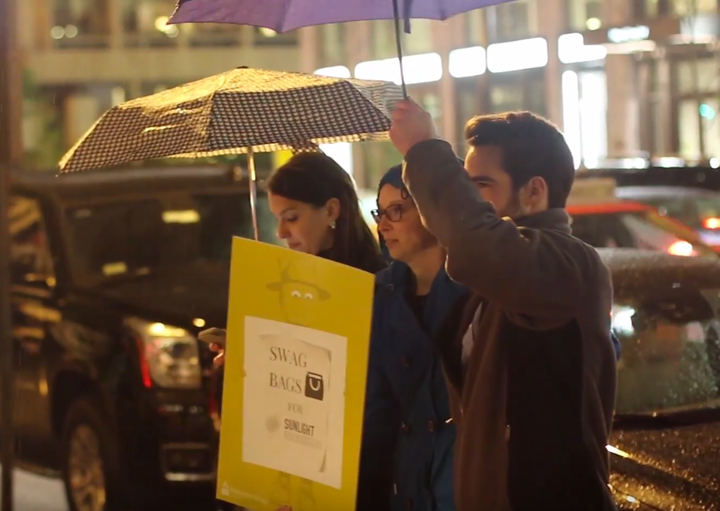 Rain could not stop the Sunlight Foundation staff members from soliciting partygoers for their swag bags -- and making a political point in the process.