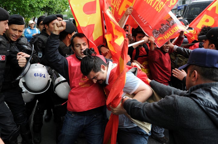 Turkish riot police scuffle with a group of protesters as they attempted to defy a ban and march on Taksim Square.