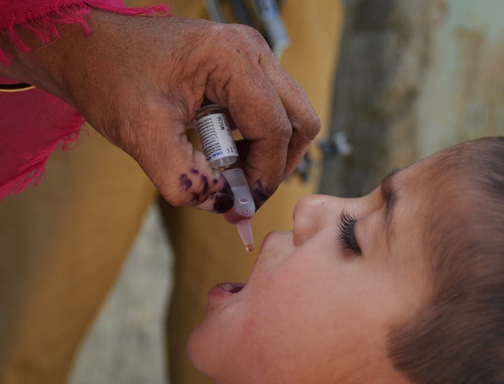 A Pakistani health worker administers polio drops to a child during a polio vaccination campaign in Quetta on April 26, 2016. Islamist outfits including the Pakistani Taliban say the polio vaccination drive is a front for espionage or a conspiracy to sterilise Muslims. / AFP / BANARAS KHAN (Photo credit should read BANARAS KHAN/AFP/Getty Images)