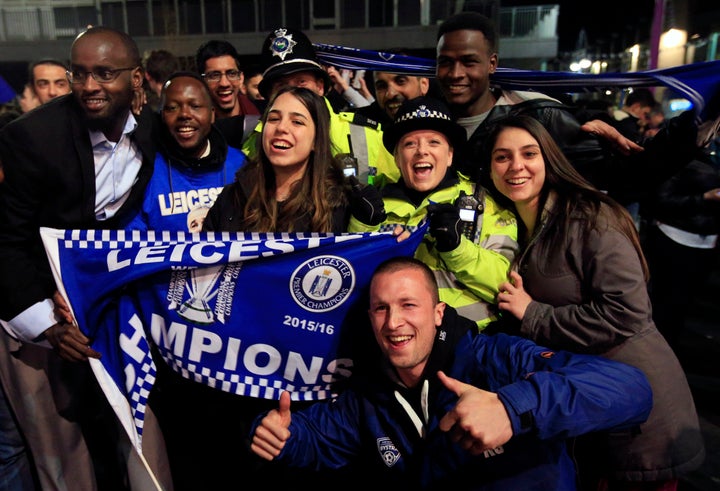 <strong>Police join in with the Leicester City fans in Leicester as they celebra</strong>te.