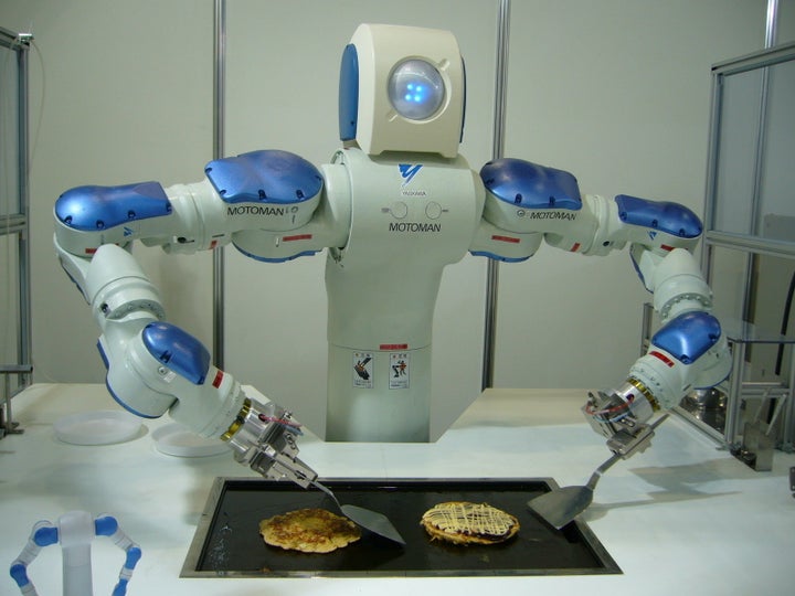 A robot prototype practices his cooking skills.