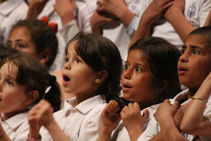 Refugee children sing in the Sonbola choir, an NGO focused on education.