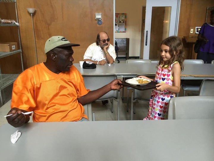 A tiny volunteer from Alabama's Birmingham Islamic Society serves food for National Muslim Soup Kitchen Day.