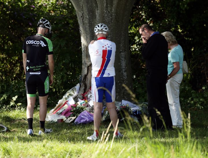 <strong>Cyclists look at floral tributes to Donald Lock at the scene</strong>