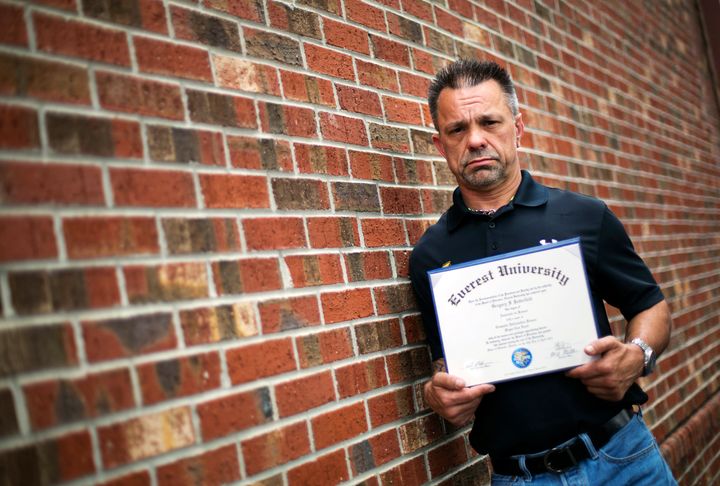 Shane Satterfield, a roofer who owes more than $30,000 in debt for an associates degree in computer science, holds his Everest diploma in March 2016. "I graduated in April at the top of my class, with honors," he said. "And I cant get a job paying over $8.50 an hour." Corinthian Colleges operated the Everest chain before it filed for bankruptcy in 2015.