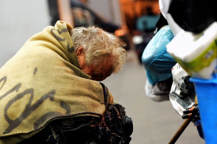 A homeless woman sleeps at the Termini train station in Rome in November 2014. This week, judges in Italy's Supreme Court of Cassation ruled that a homeless man who stole a sausage and some cheese did not commit a crime because his actions were fueled by an "immediate need for nourishment."