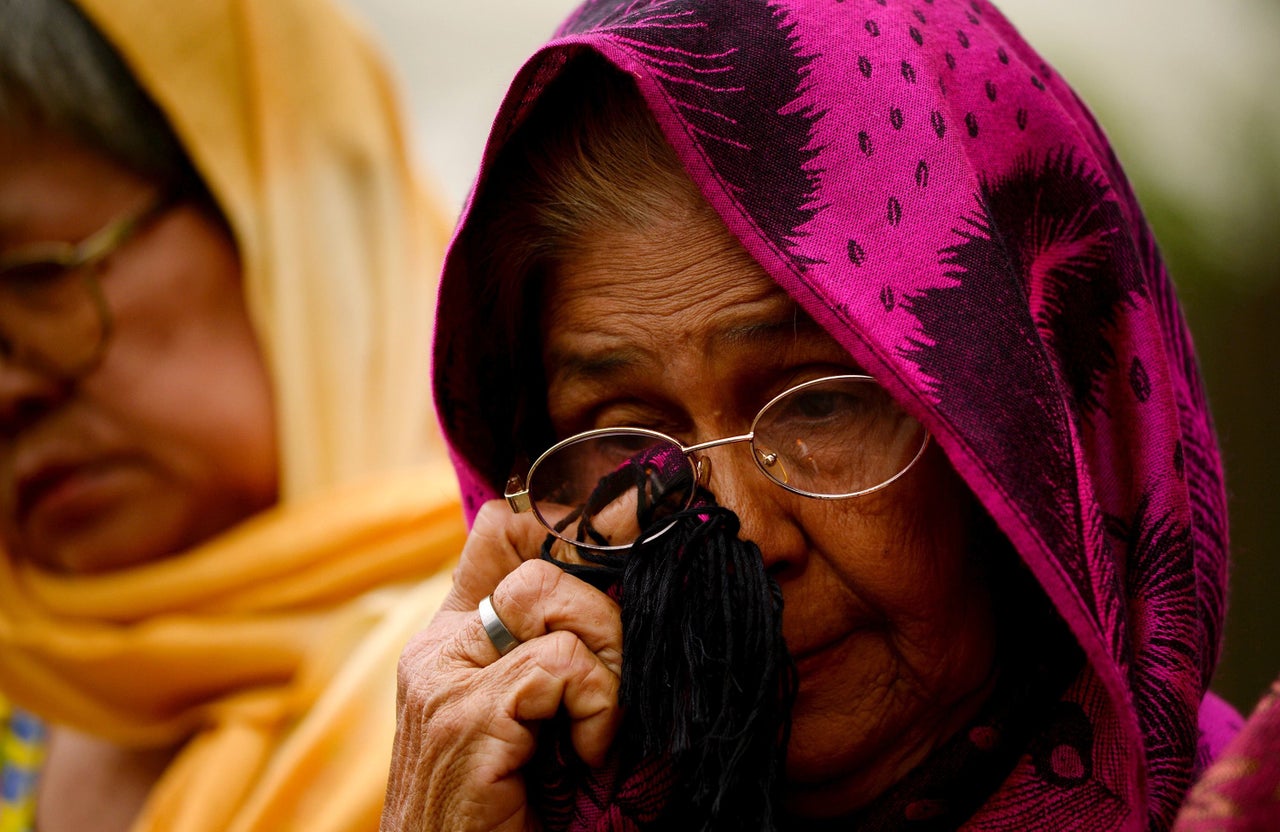 A protesting woman wipes away tears during Japanese Emperor Akihito's visit to Manila.