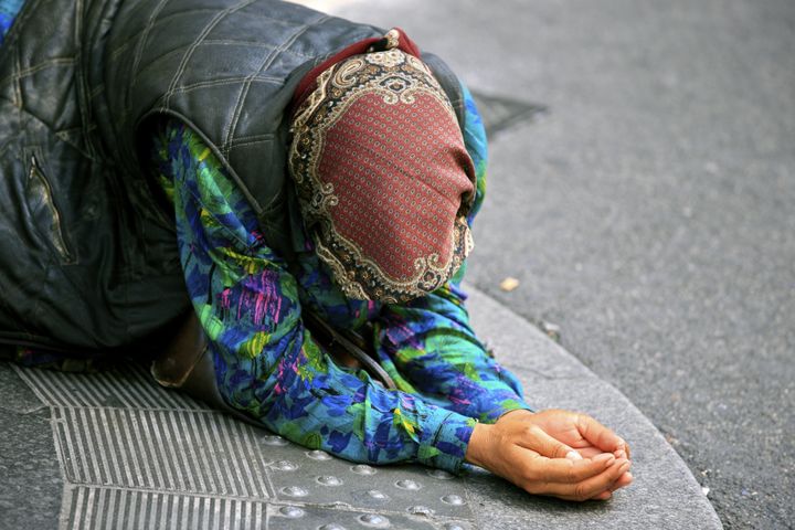 A homeless woman begs in Rome (file picture)