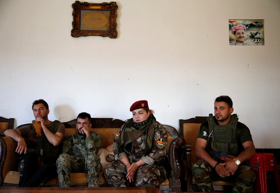 Nauzad sits with other fighters at the site.