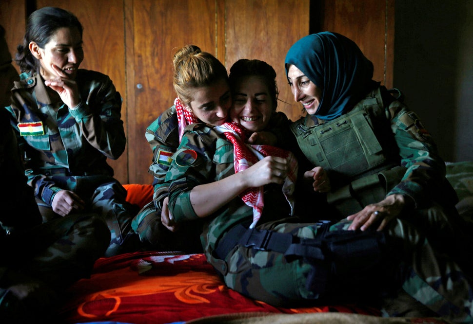 Fighters share a moment in a bedroom near their deployment site.
