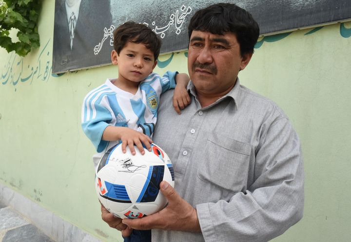 Murtaza and his father in their new home in Pakistan