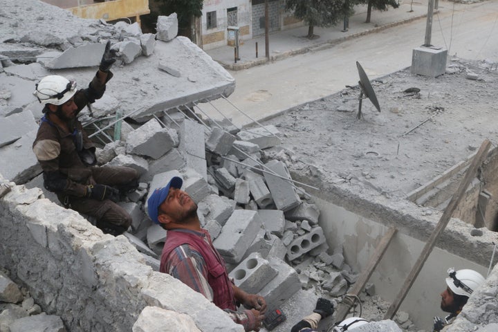 Civil defense members work at a site hit by an airstrike in the rebel held area of Aleppo on Tuesday. The surge in fighting w