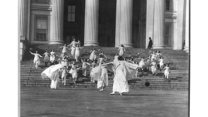 Suffragists and young girls carrying balloons on the steps of the U.S. Treasury, 1913 