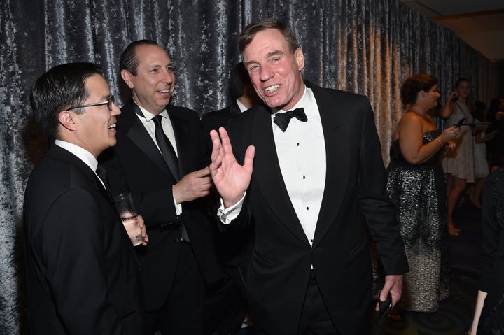 Sen. Mark Warner (D-Va.), pictured on the right, argues that big business activism is an antidote to the current populis