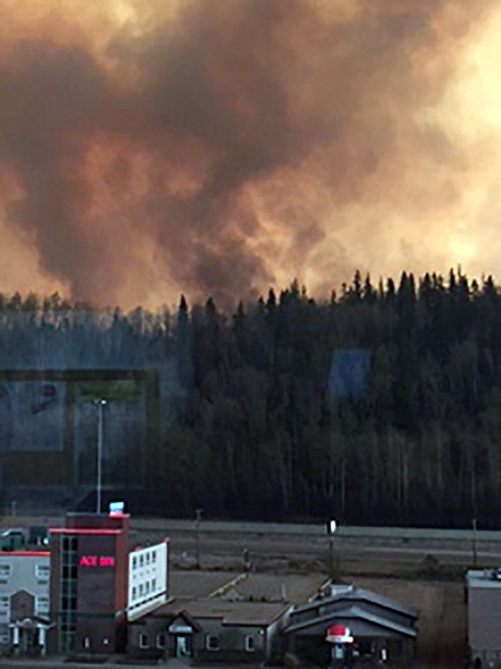 Smoke rises from a wooded area in the Canadian town of Fort McMurray, where wildfires raged on Tuesday.
