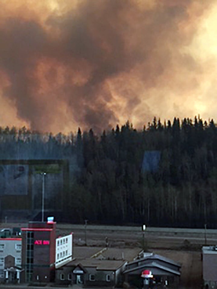 Smoke rises from a wooded area in the Canadian town of Fort McMurray, where wildfires raged on Tuesday. 