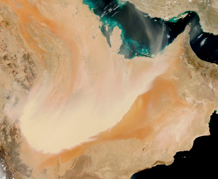 A dense wall of dust barrels across the Arabian Peninsula.