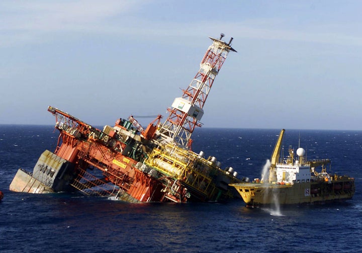 A rescue ship is seen alongside the P-36 oil rig owned by Brazilian oil giant Petrobras off the coast of Rio de Janeiro on March 19, 2001.