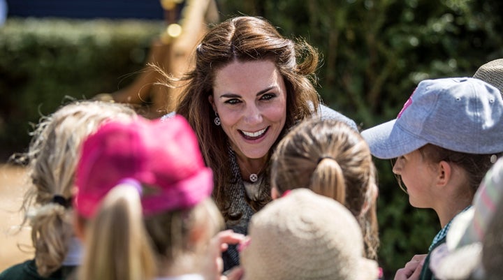 The Duchess of Cambridge talks to local school children at Hampton Court Palace.