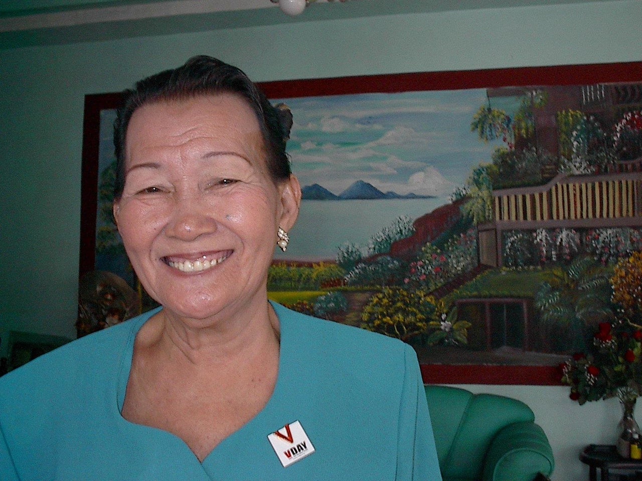 Prescilla Bartonico was held captive by the Japanese army for three months in 1943. She told Galang that she was never able to sleep a full night after her imprisonment, so she'd paint murals using tissue, cardboard and children's tempera paints while her family slept. Here, she smiles in front of one of her creations.