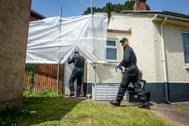 Police enter the former home of David and Pauline Williams