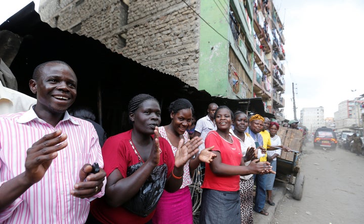 Residents applauded as rescue workers evacuated a woman from the rubble. The residential block collapsed after days of h
