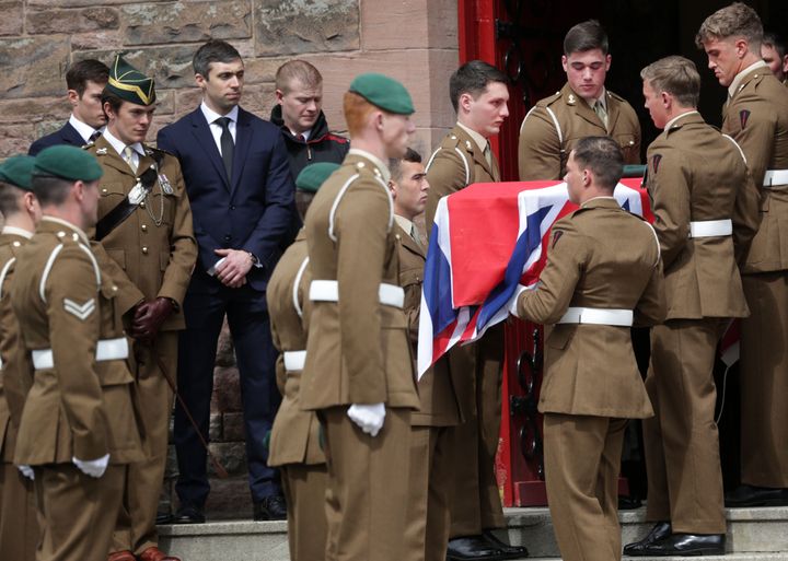 Military colleagues hold the coffin of Captain David Seath, who died after collapsing during the London Marathon.