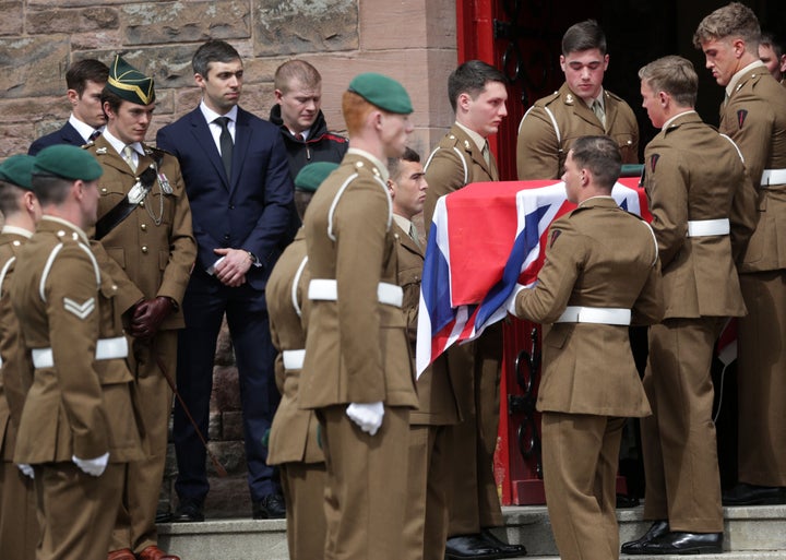 Military colleagues hold the coffin of Captain David Seath, who died after collapsing during the London Marathon.