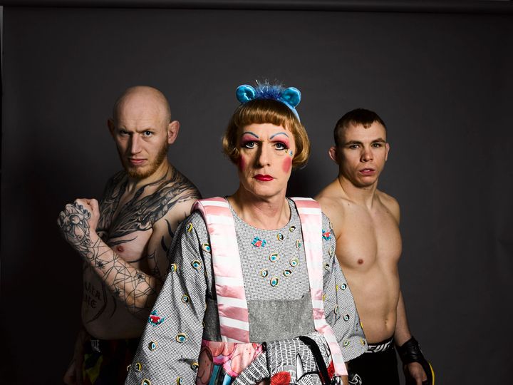Grayson Perry as Claire with two cage fighters 