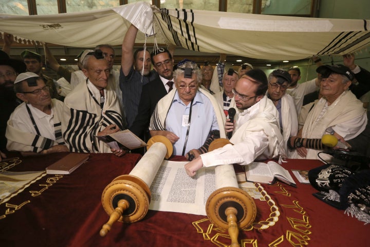 Dozens of Jewish holocaust survivors read from the Torah scrolls during the ceremony.