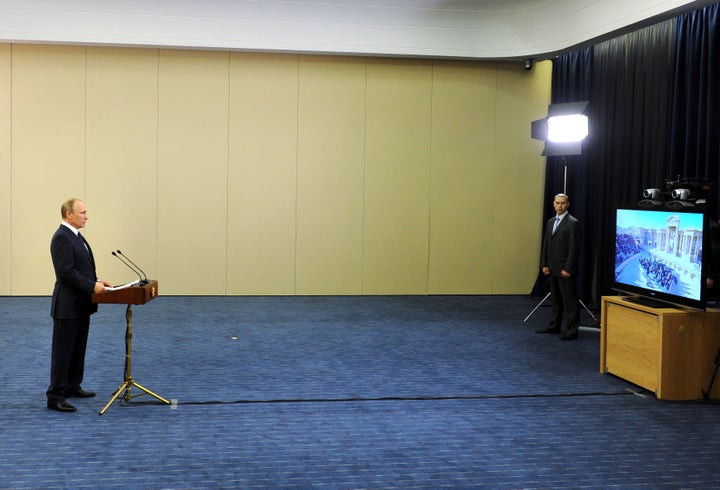 Russian President Vladimir Putin attends a video conference ahead of the classical music concert.