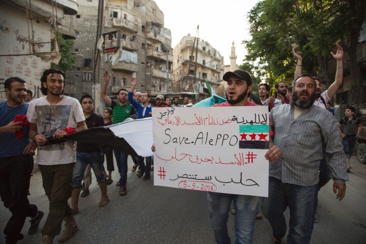 The city of Aleppo has borne the brunt of the fighting. Above, Syrians protest in a rebel-held district of Aleppo on Thursday.