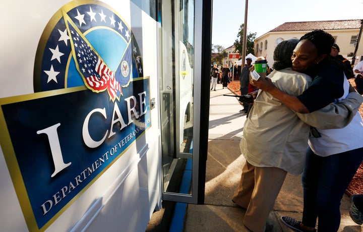 LOS ANGELES, CA - NOVEMBER 04, 2015 -- Charlie M. Lonon, left, with the VA Medical Center Long Beach hugs Melinda Estes, right, with the VA Outreach as they set up to assist veterans attending the VA Homeless-to-Housed Veteran's Stand-down event Wednesday November 04, 2015 which started at 6:00 a.m. at the Veteran's Center in West Los Angeles and will continue through Thursday, November 05. The event is an attempt to gather vets and offer services on the VA campus. (Al Seib / Los Angeles Times via Getty Images)