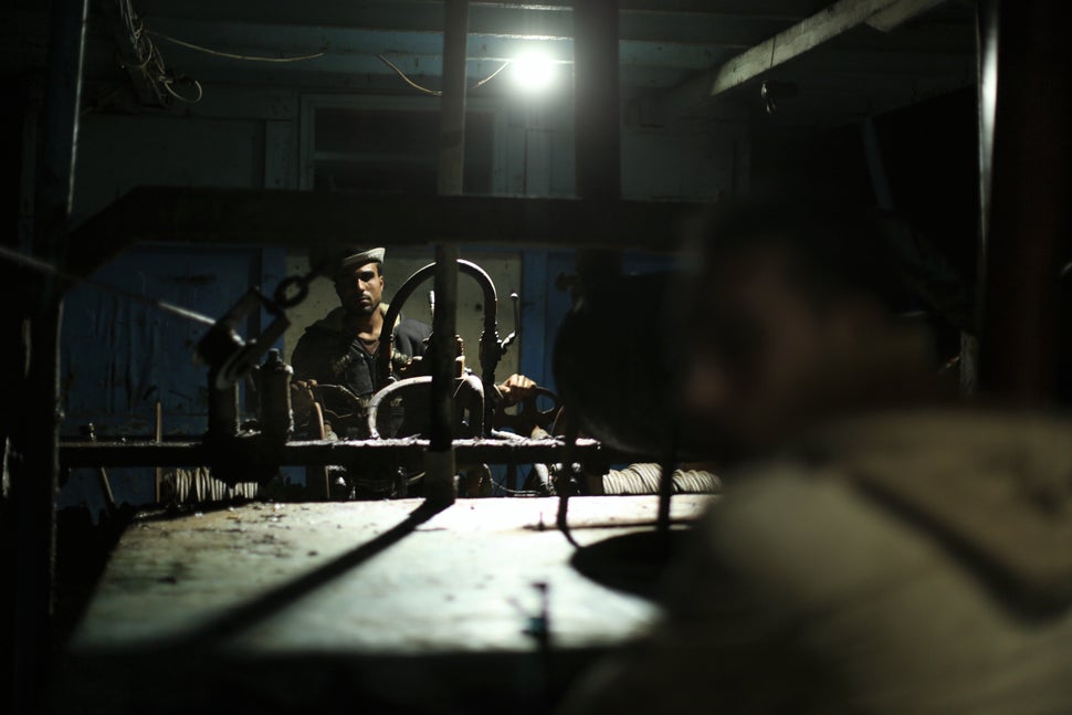 Palestinian fisherman pull out fishing nets using mechanical levers.