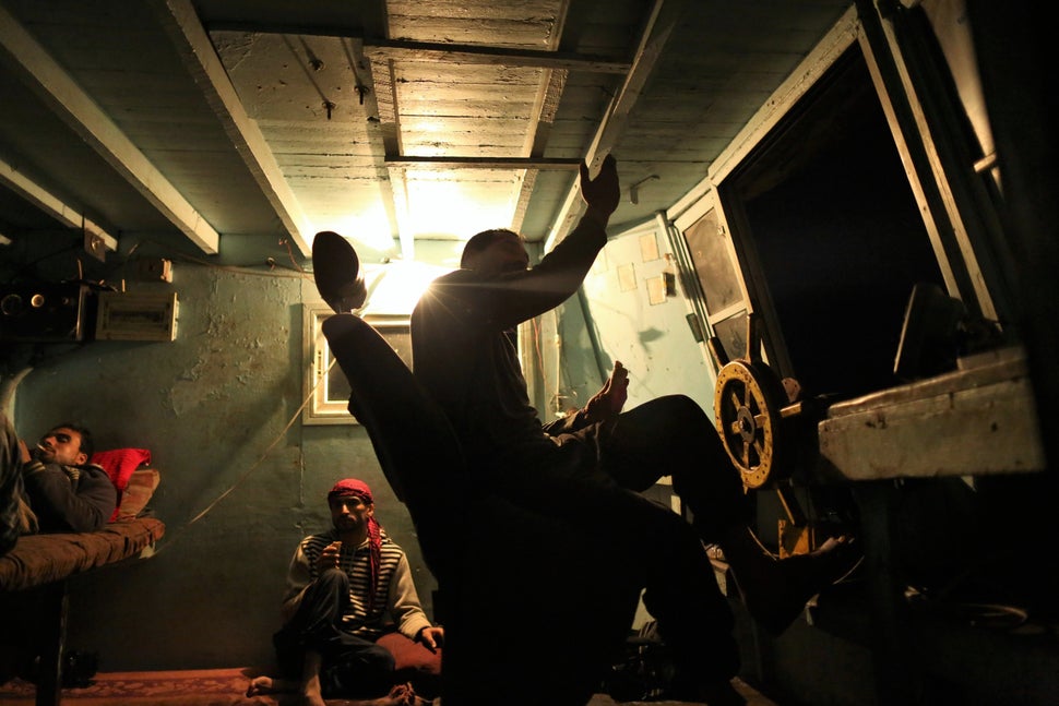 Palestinian fishermen take a rest while the captain of the ship, Raed Abu Owda, tells stories about his experiences
