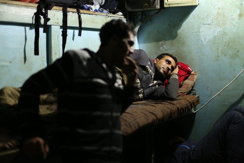 Mohammed Abu Owda takes a rest in the captain's cabin at midnight before they lift the nets again.