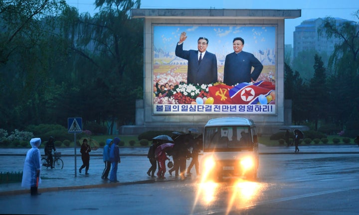 The late Kim Il-sung and his son Kim Jong-il are seen on a sign in Pyongyang, North Korea, on May 3. Kim Jong-un may be eleva