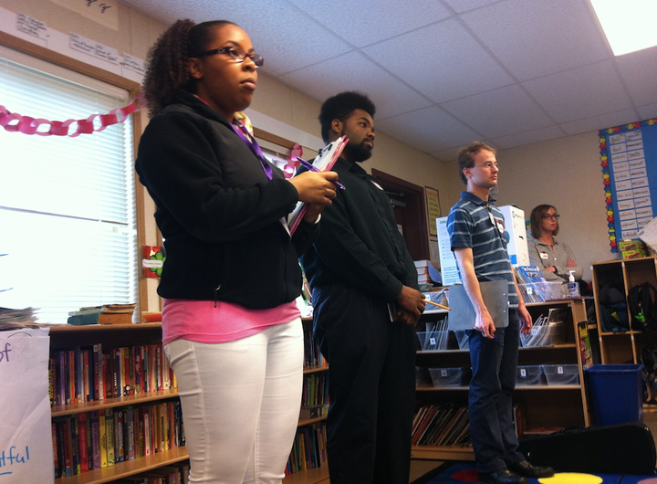 Graduate students observe as a classmate delivers a lesson about similes and metaphors to a fifth-grade class at Adams Elementary School.