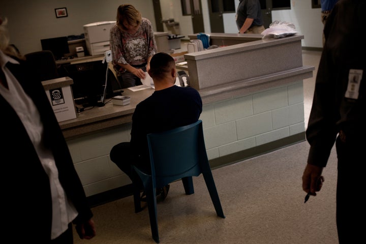 A detainee undergoes processing at what was then known as Karnes County Civil Detention Center on Sept. 9, 2013. The Texas facility was converted into a family detention center in 2014, and now seeks a license as a child care facility.