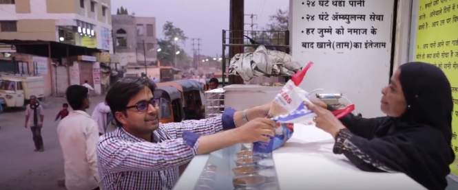 A man depositing food at Roti Bank. (screenshot from AJ+ video)