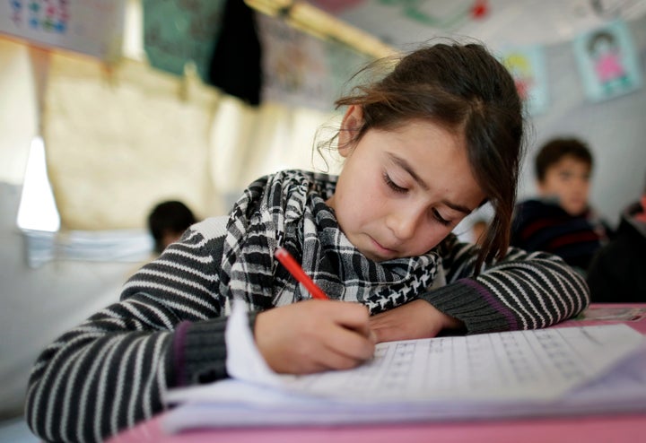 ZAHLE, LEBANON - DECEMBER 09: Girl at a provisional elementary school of an informal tented settlement of Syrian refugees on December 09, 2014 in Zahle, Lebanon. The ongoing civil war in Syria continues to force masses of Syrians into neighboring Lebanon. (Photo by Thomas Koehler/Photothek via Getty Images)