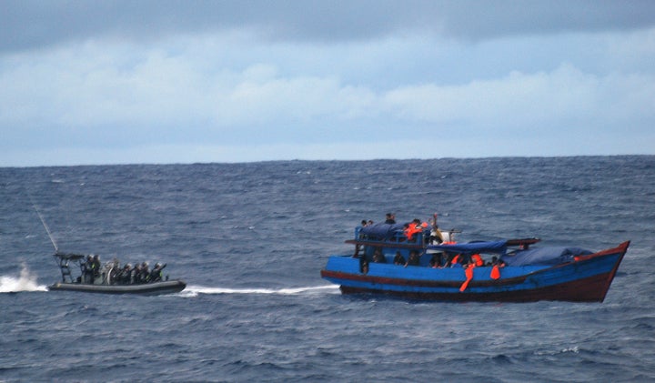Australia says it is necessary for its navy to intercept migrants' boats, as pictured above in 2010, in order to deter danger