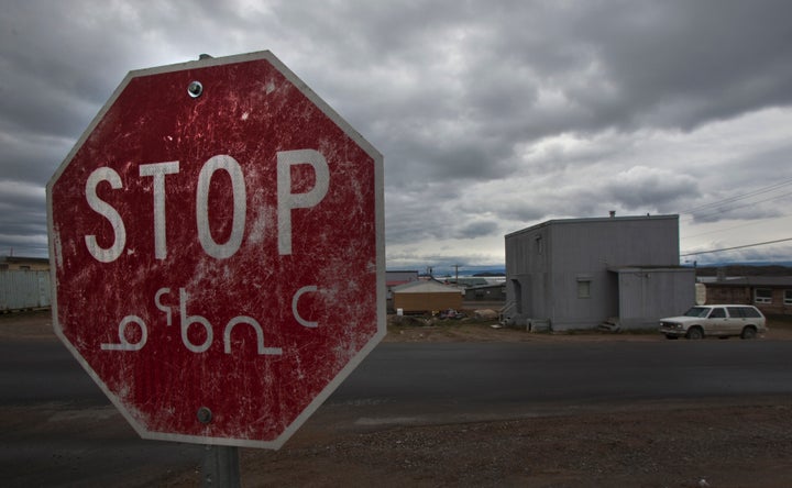 A weathered stop sign in both English and the Inuit language Inuktitut is shown in Iqaluit, Nunavut in the Canadian Arctic. Inuit languages are rapidly declining in Alaska, Russia and parts of Canada.