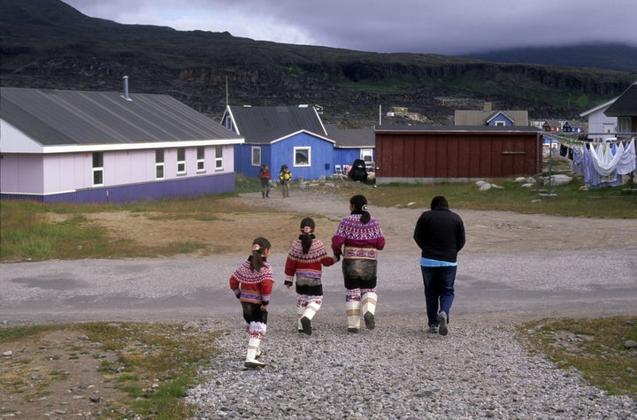 The push to standardize the script has faces resistance from those wary of change. Above, Inuit mother and girls wear traditional costumes in Qeqertarsuaq, Greenland in 2010.