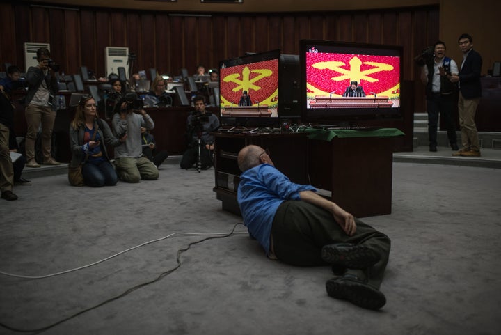 Journalists watch a television broadcast of North Korean leader Kim Jong-Un delivering a speech at the 7th Workers Party Cong