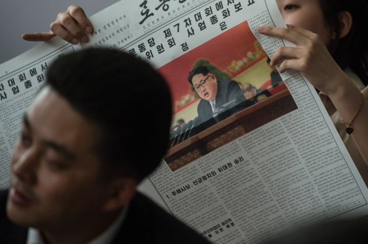 Journalists watch a television broadcast of North Korean leader Kim Jong-Un delivering a speech at the 7th Workers Party Cong