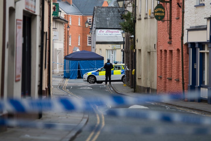 The man was found unconscious and injured in Brecon town centre