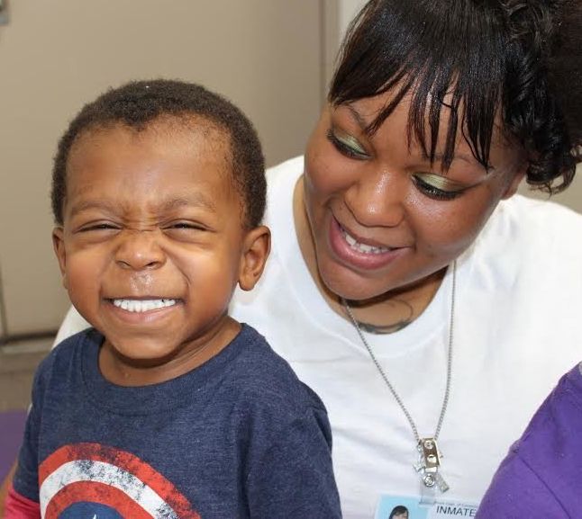 Kristan, 2, visits his mother for the first time in the Decatur Correctional Facility in Decatur, Illinois on Saturday.