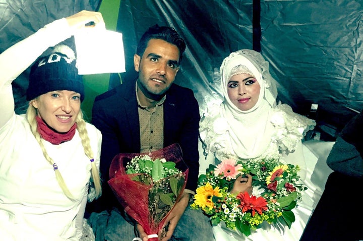 Alison Thompson, the volunteer who organized the wedding, poses with the couple.