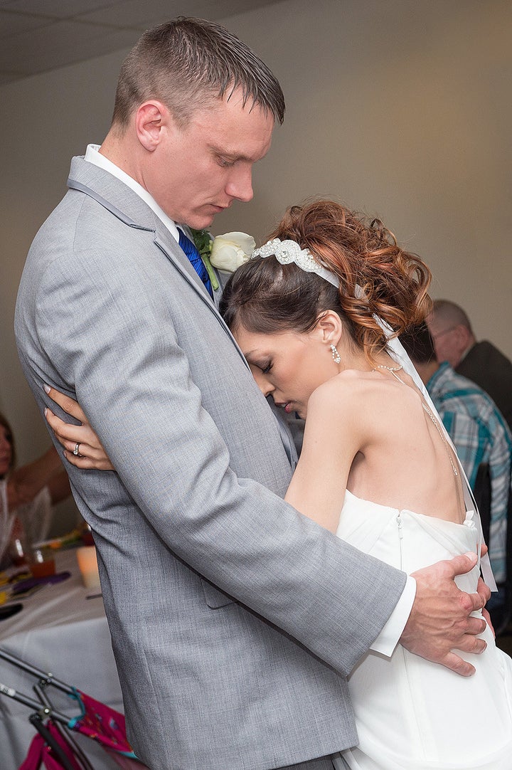 Brandon Thomas and Destini Schafer have their first dance at their reception held in a conference room at Memorial Medical Center.